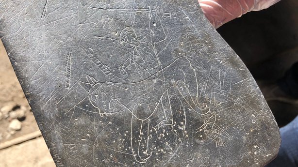 Image of man riding horse carved on slate found in Dublin