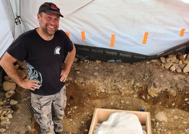 Mariusz Stepien standing next to hoard courtesy Crown Office Communications/PA.